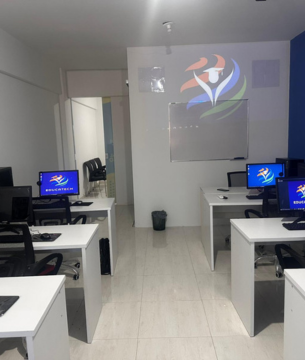 Sala de aula moderna da EducaTech, com computadores e cadeiras para os alunos.